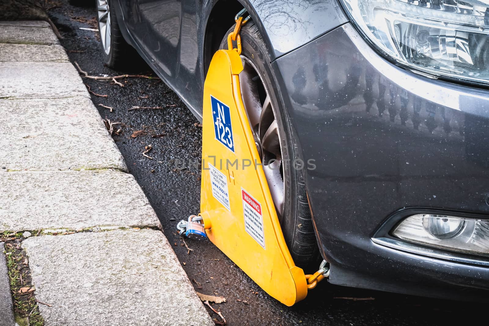 Car blocked by a wheel clamp in  Dublin, Ireland by AtlanticEUROSTOXX