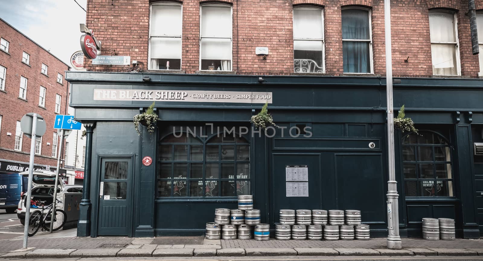 Dublin, Ireland - February 12, 2019 - beer barrels piled up on the street in front of an Irish pub on a winter day