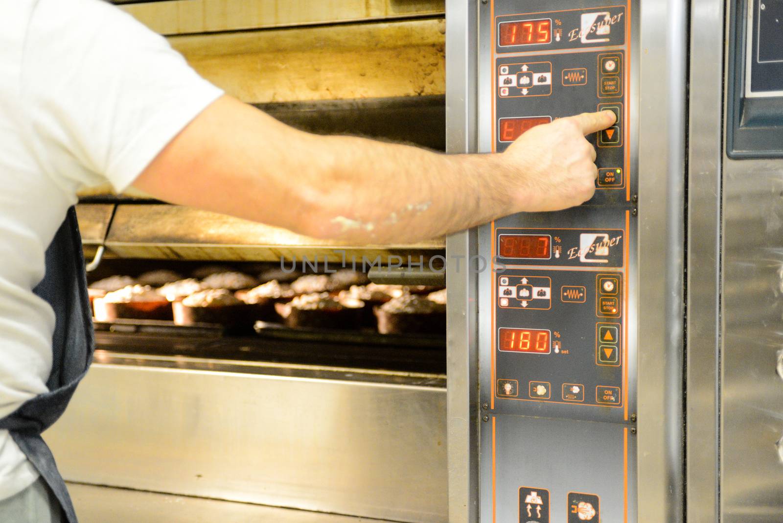 pastry chef in professional kitchen preparing and baking milanese panettone in christmas time. by verbano