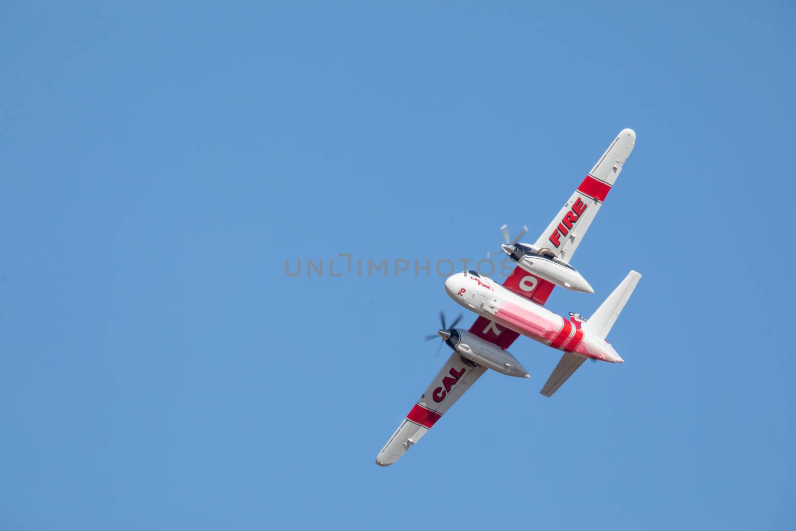 Winchester, CA USA - June 14, 2020: Cal Fire aircraft preparingto drop fire retardant on a dry hilltop wildfire near Winchester, California.