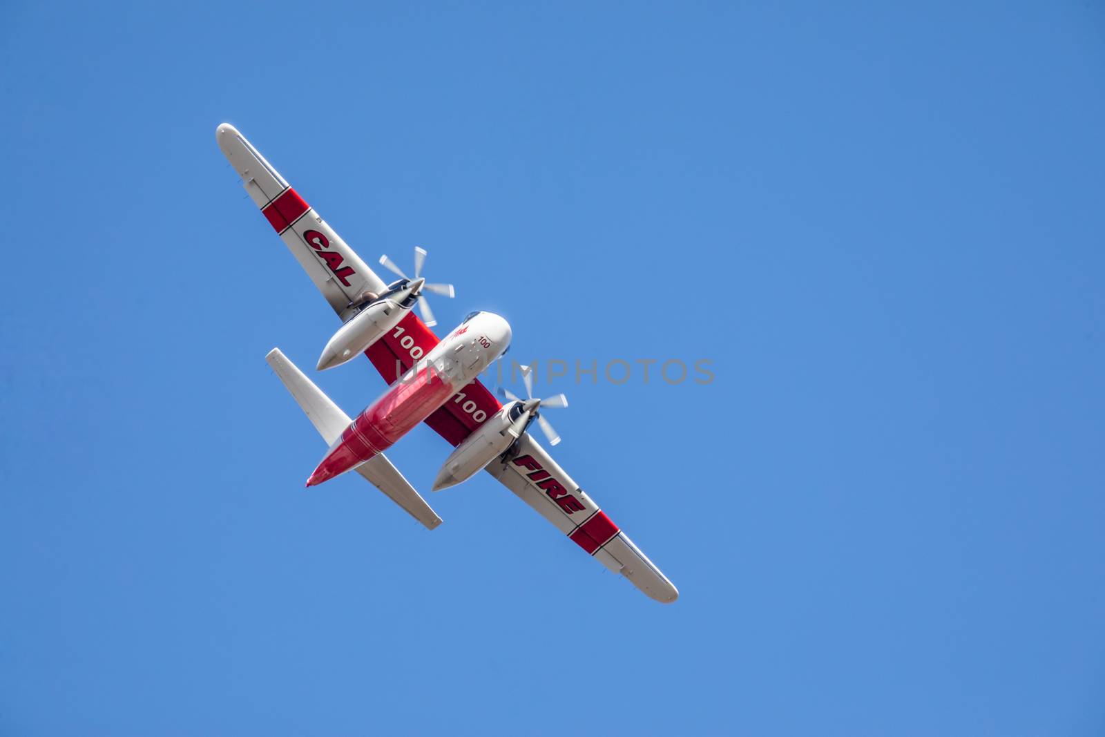 Winchester, CA USA - June 14, 2020: Cal Fire aircraft preparingto drop fire retardant on a dry hilltop wildfire near Winchester, California.