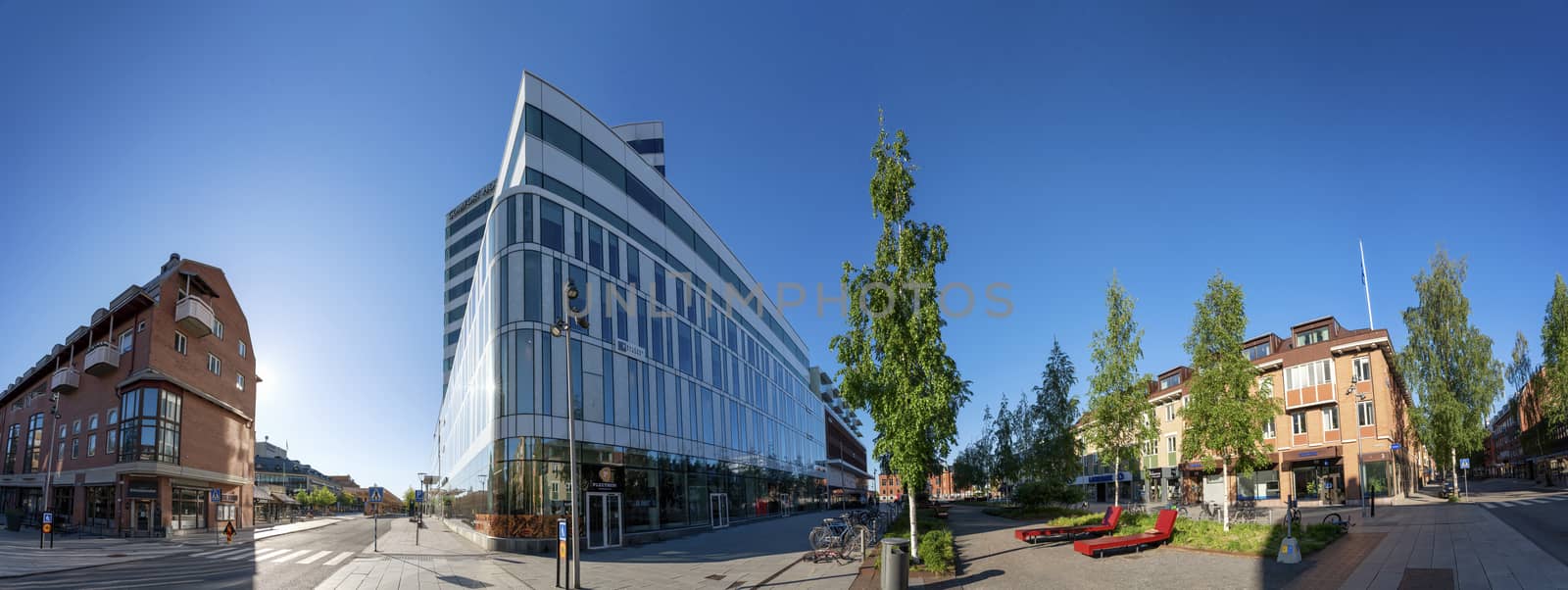 UMEA, SWEDEN - JUNE 10, 2020: Scenic panorama of downtown - nice mixture of modern and old buildings. Early sunny summer day, no people, bright colors of modern architecture and birches, Vasterbotten by skydreamliner