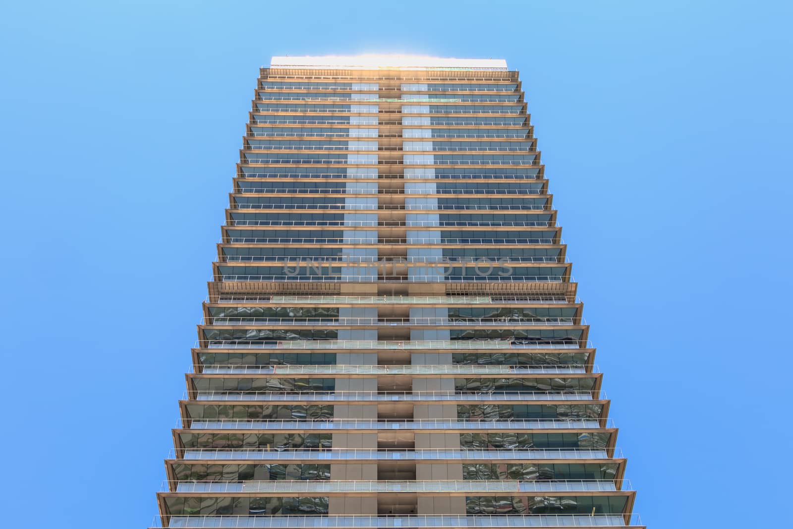 BARCELONA, SPAIN - June 21, 2017 : architectural detail of the MAPFRE tower during the summer, a skyscraper designed by the architects Inigo and Enrique de Leon and built for the 1992 Summer Olympics