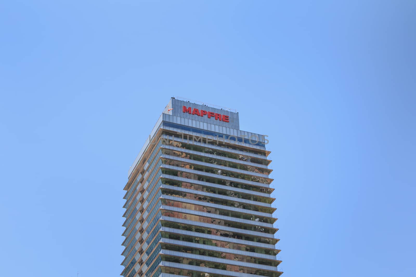 BARCELONA, SPAIN - June 21, 2017 : architectural detail of the MAPFRE tower during the summer, a skyscraper designed by the architects Inigo and Enrique de Leon and built for the 1992 Summer Olympics