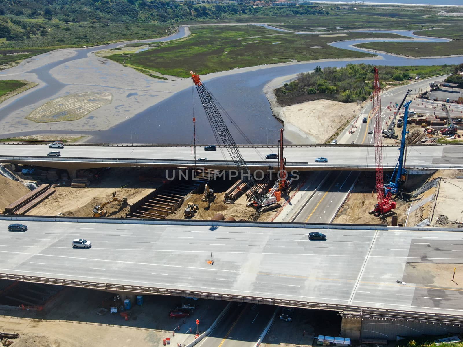 Aerial view of highway bridge construction over small river, San Diego, California, USA