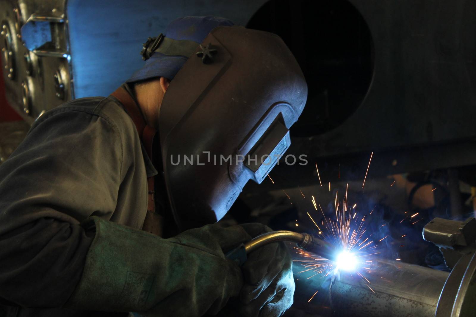 Welder performs welding work semi-automatic electric arc welding. MIG welding.