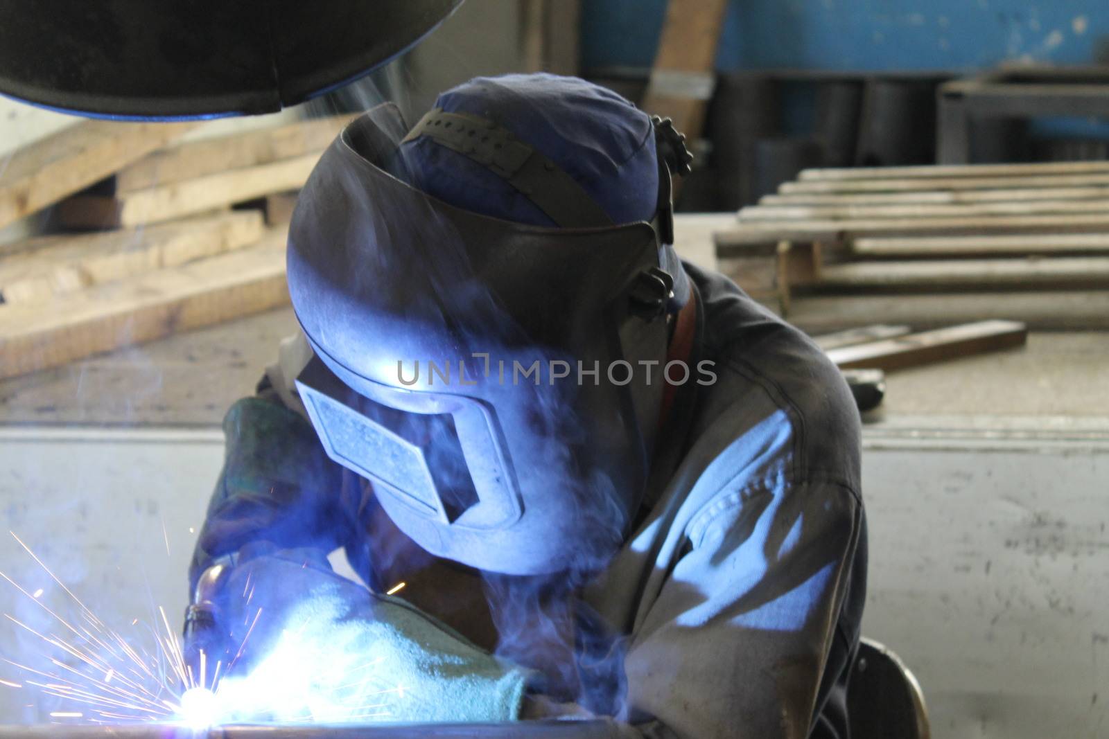 Welder performs welding work semi-automatic electric arc welding. MIG welding.