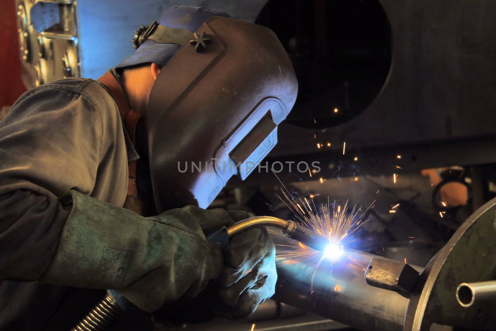 Welder performs welding work semi-automatic electric arc welding. MIG welding.