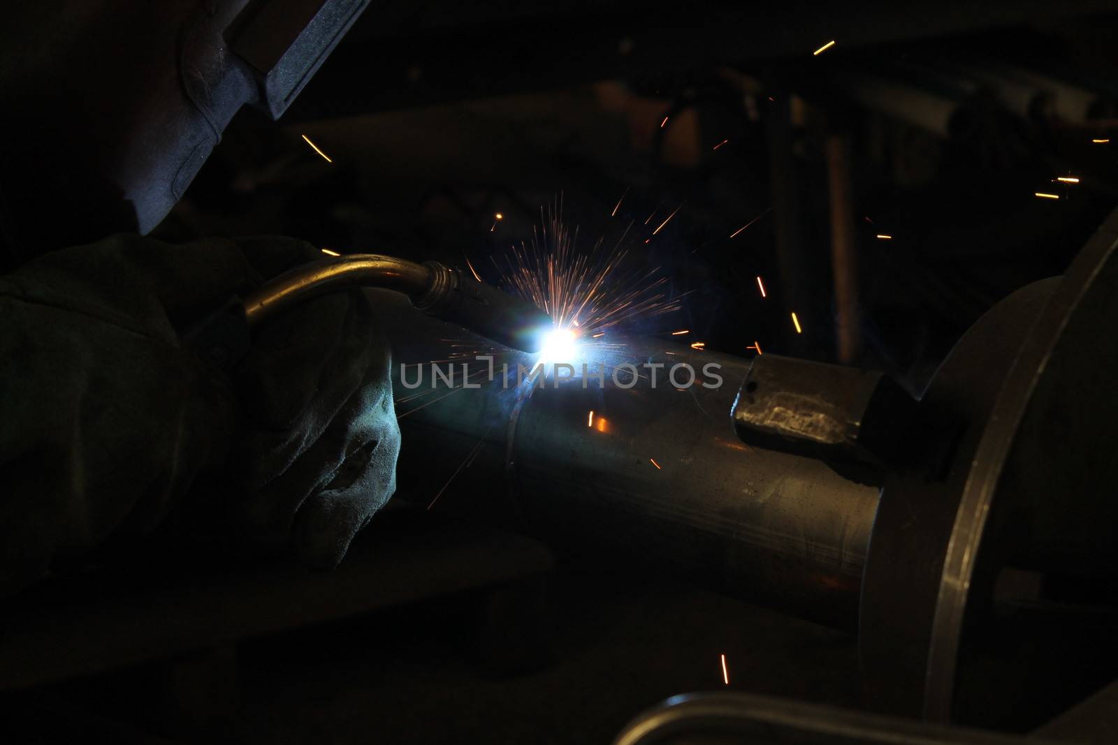 Metal welding. Sparks from electric heating. Iron, materials.Artistic welding sparks light, industrial background .