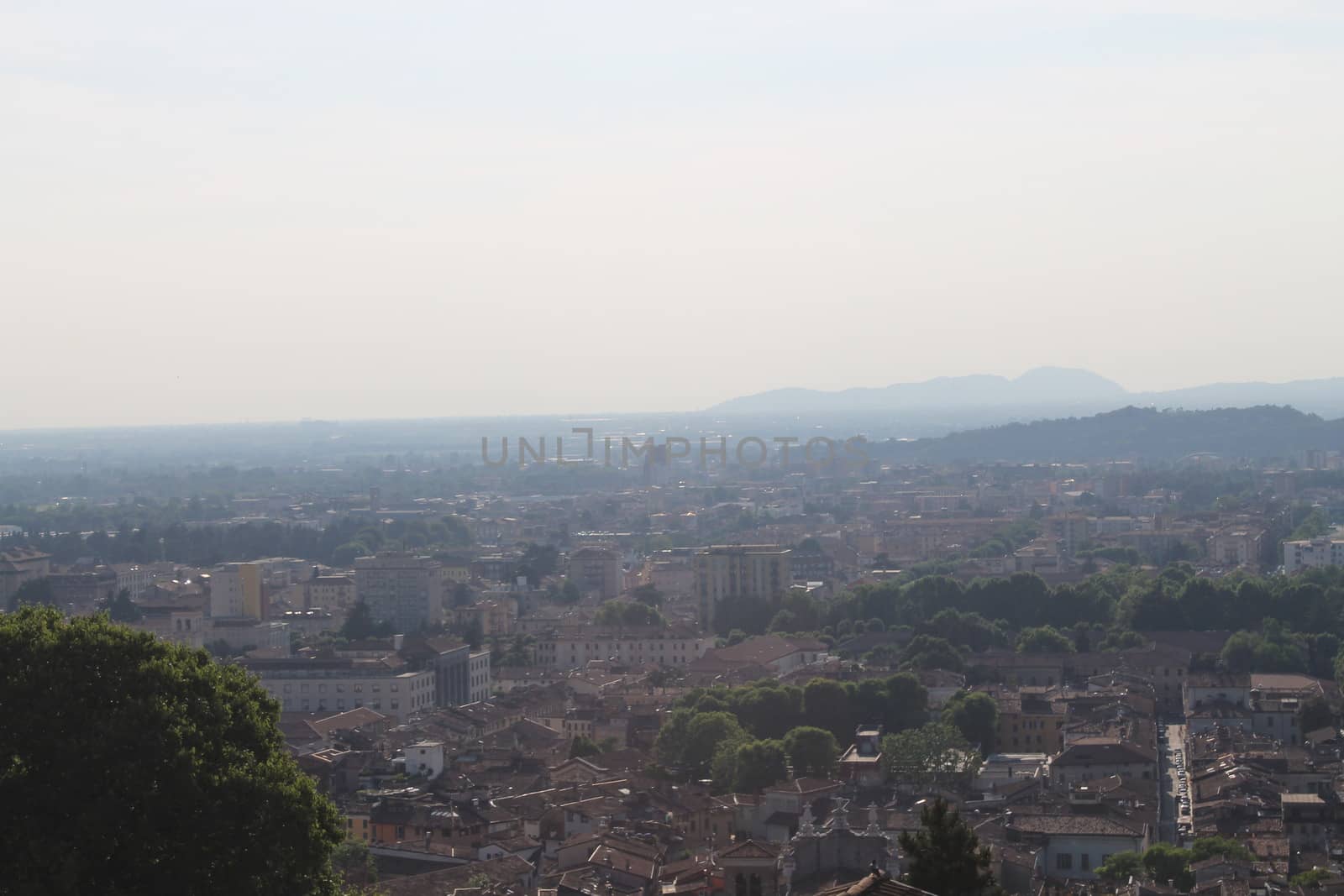 Aerial panoramic view of old historical city centre of Brescia city with churches, towers and medieval buildings with red tiled roofs, Lombardy, Northern Italy. Cityscape of Brescia town.