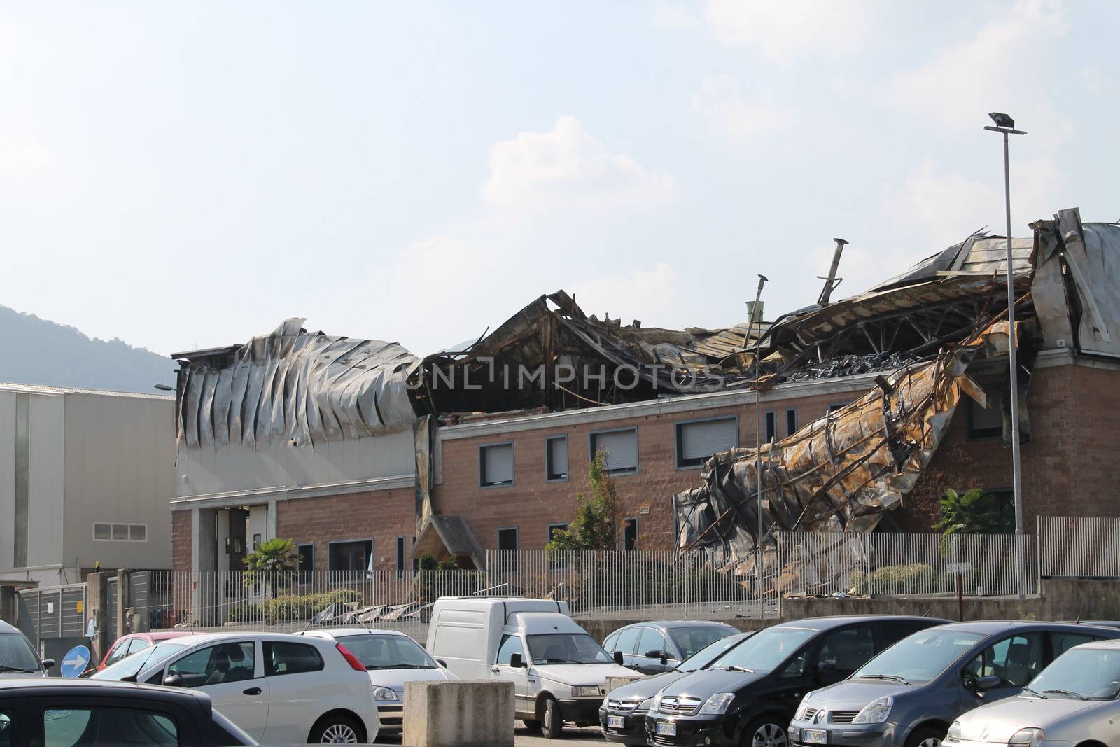 Facade of an industrial building after a fire against a blue sky