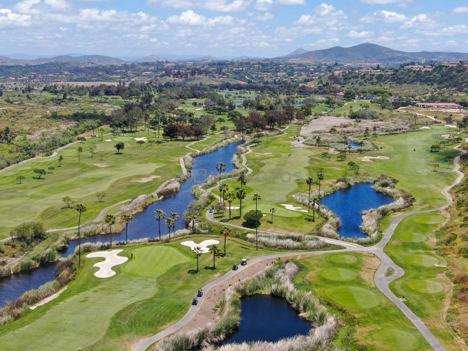 Aerial view of a green golf course in South California by Bonandbon