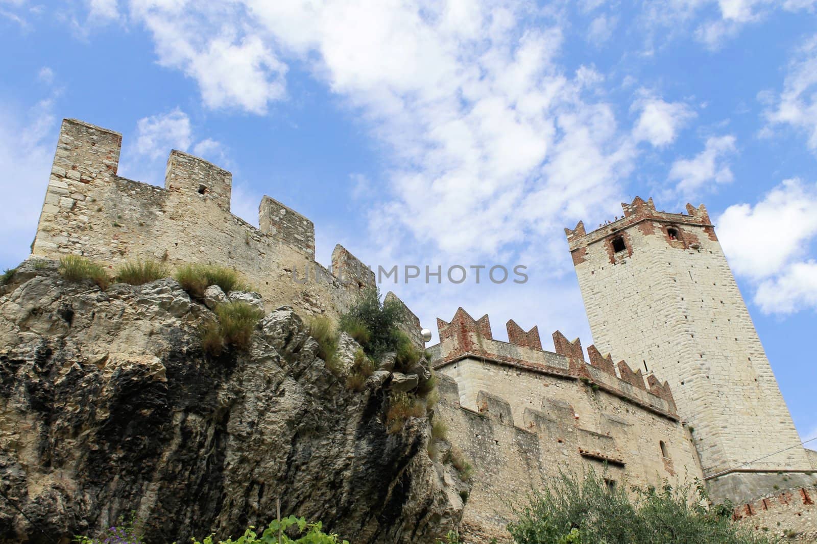 Ancient castle wall with tower in Malcesine on Garda Lake, Italy