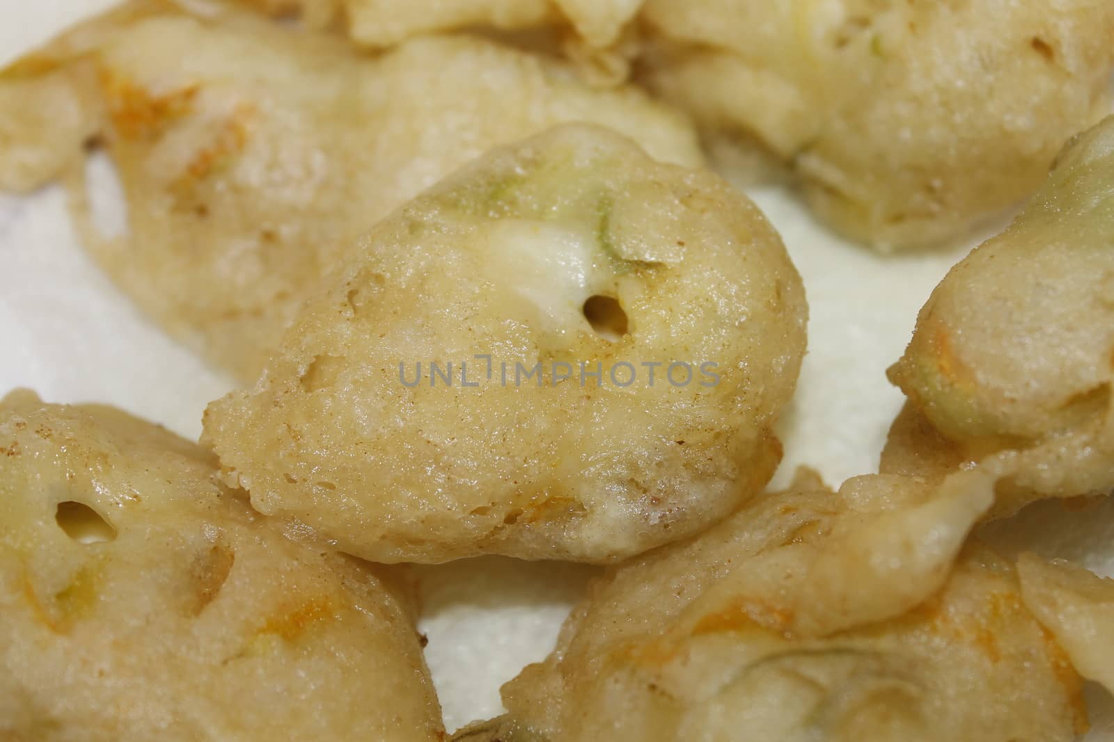 zucchini flowers in batter with mozzarella and anchovies