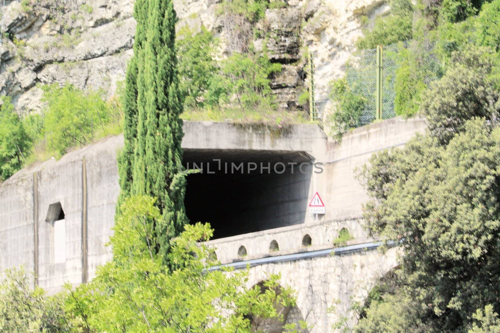 Scenic panoramic beltway road around lake Garda full of tunnels and galleries made in the rocks at the edge of a coastline