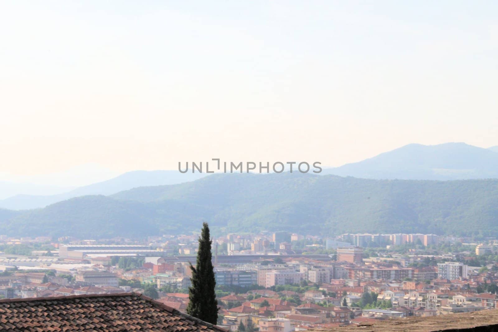 Aerial panoramic view of old historical city centre of Brescia city with churches, towers and medieval buildings with red tiled roofs, Lombardy, Northern Italy. Cityscape of Brescia town.