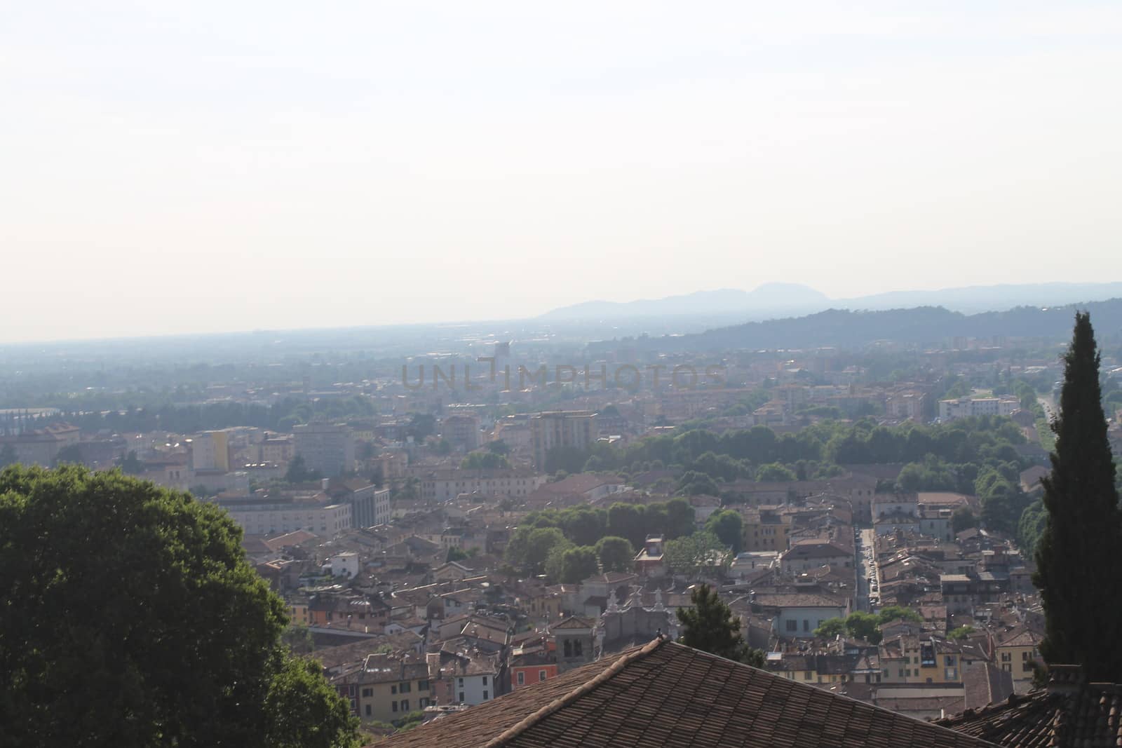 Aerial panoramic view of old historical city centre of Brescia city with churches, towers and medieval buildings with red tiled roofs, Lombardy, Northern Italy. Cityscape of Brescia town.