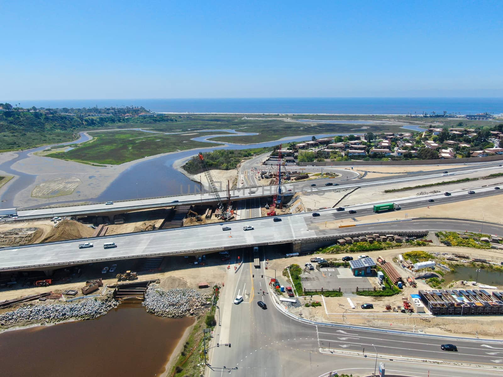 Aerial view of highway bridge construction over small river, San Diego, California, USA