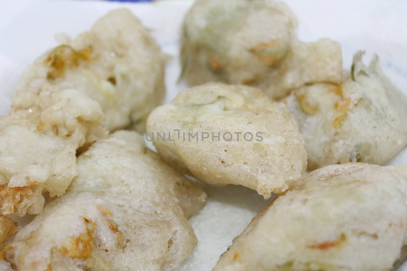 zucchini flowers in batter with mozzarella and anchovies