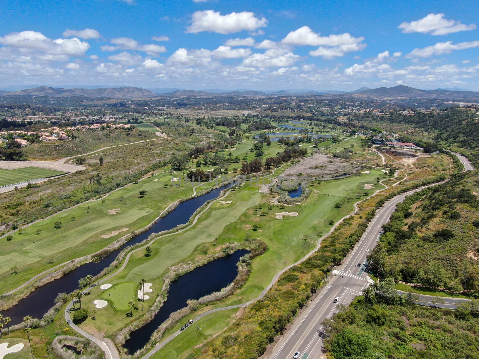 Aerial view of a green golf course in South California by Bonandbon