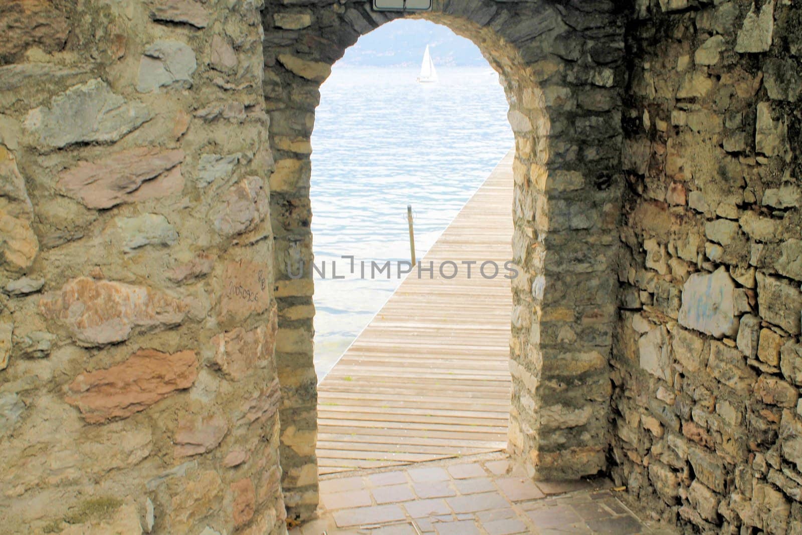 ancient stone gate on the lake in Italy