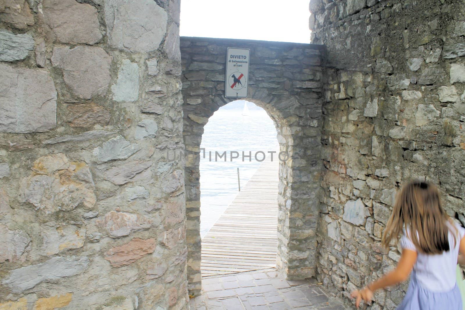 ancient stone gate on the lake in Italy