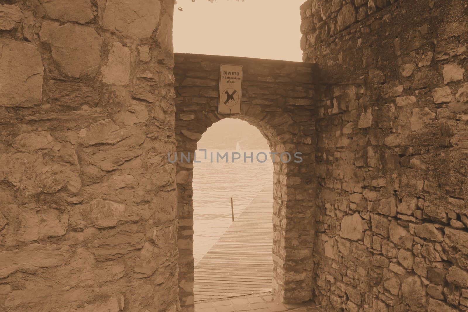 ancient stone gate on the lake in Italy