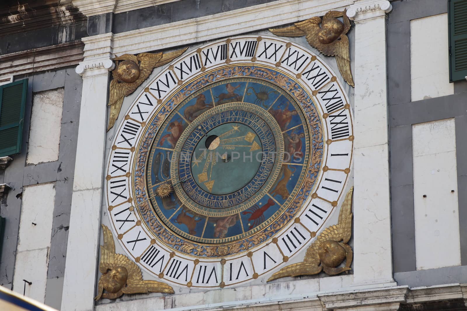 the clock tower with historical astronomical clock in Brescia, Italy