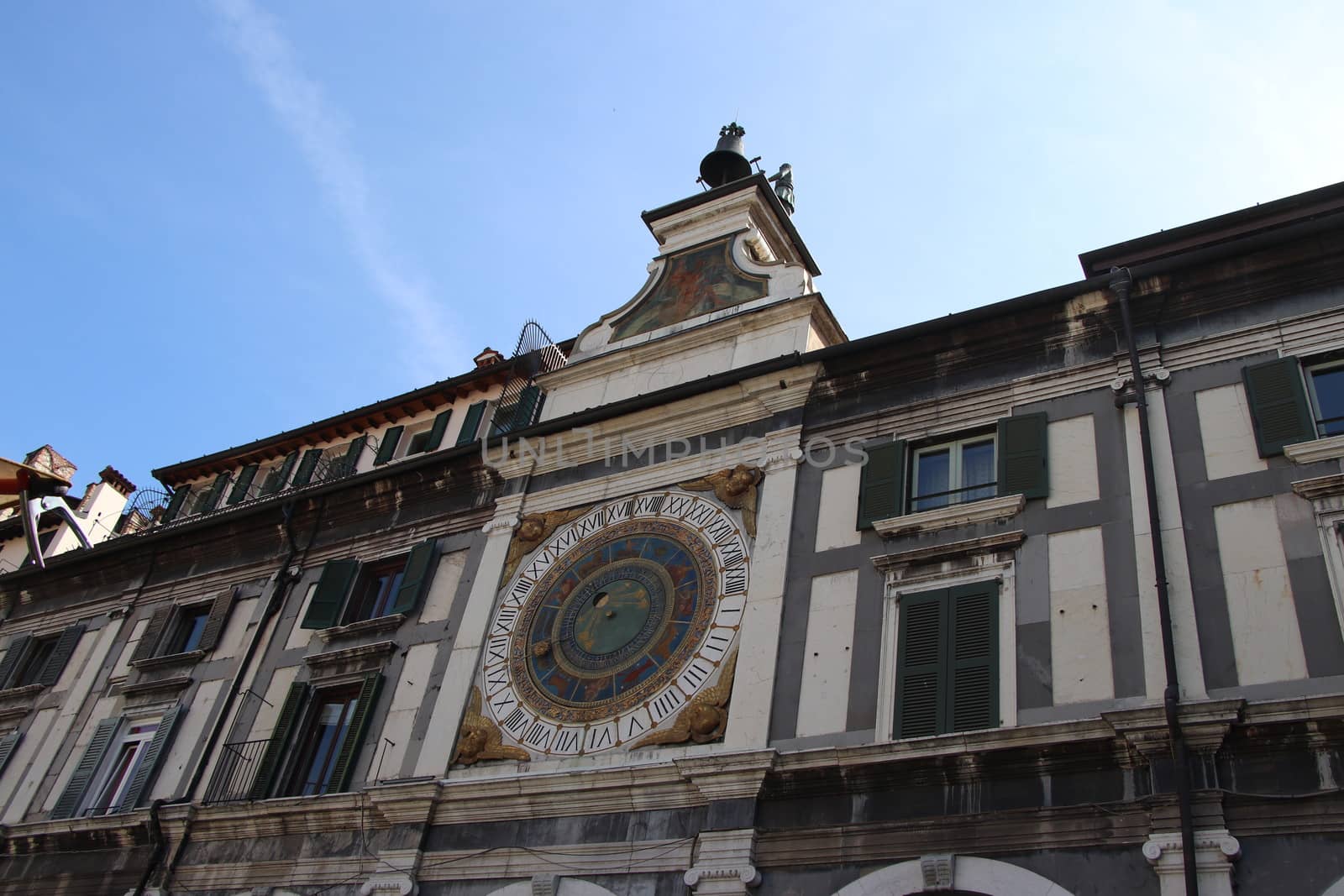 the clock tower with historical astronomical clock in Brescia, Italy