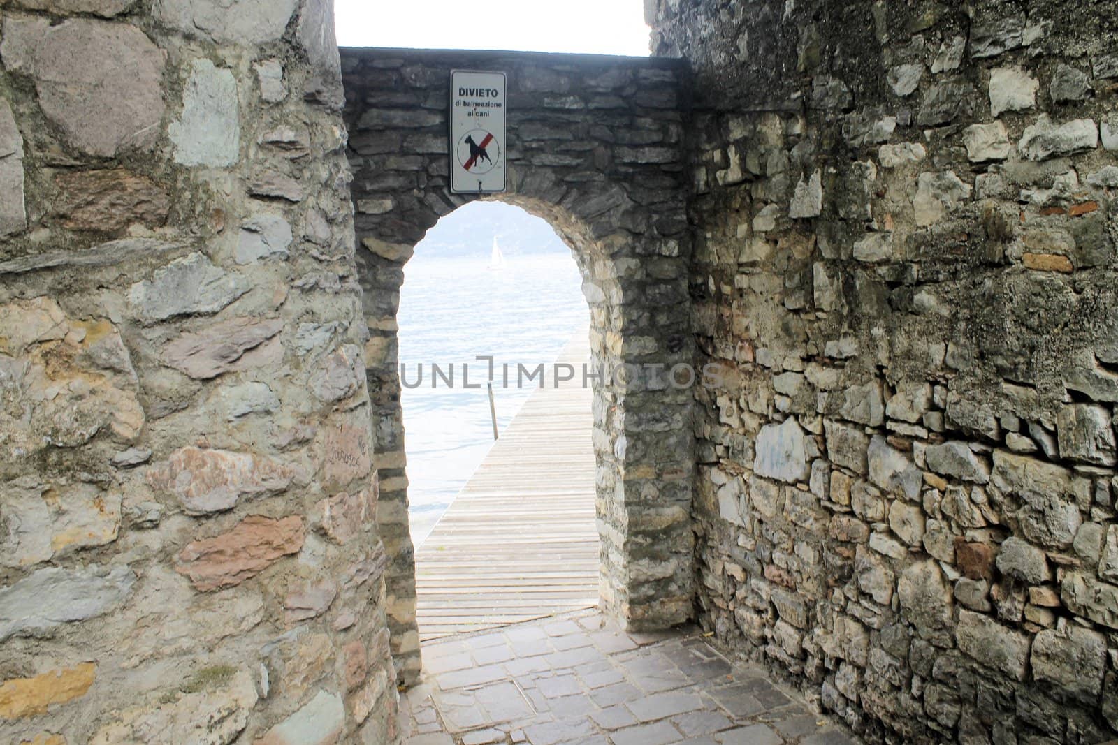 ancient stone gate on the lake in Italy