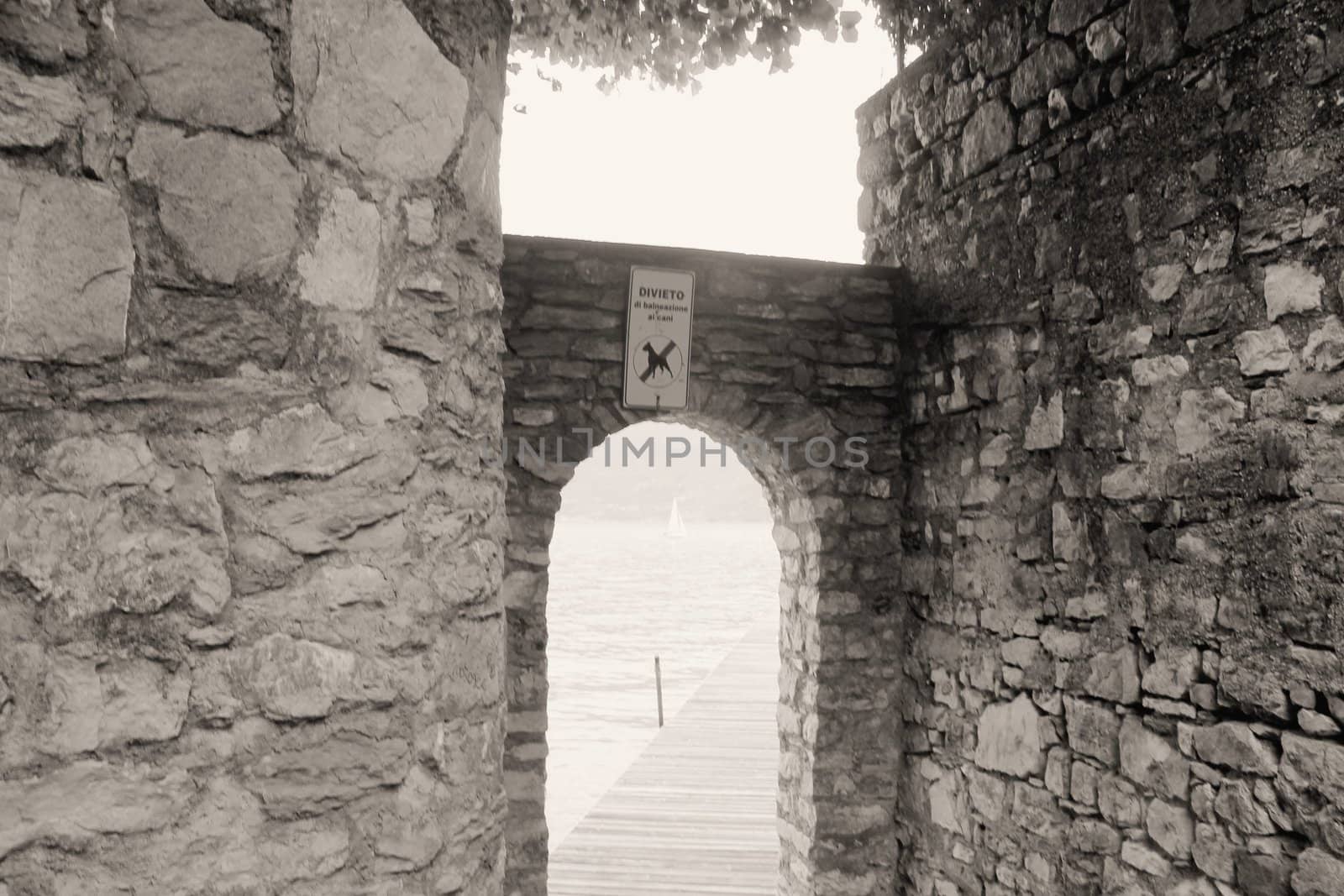 ancient stone gate on the lake in Italy