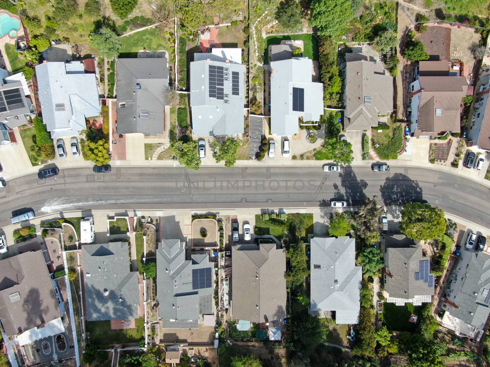 Aerial top view of upper middle class neighborhood street with residential house and swimming pool in San Diego, California, USA.