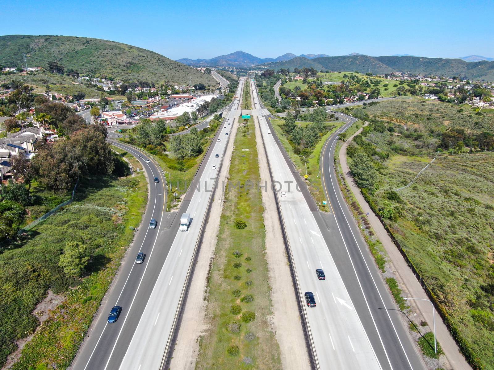 Aerial view of highway, freeway road with vehicle in movement by Bonandbon
