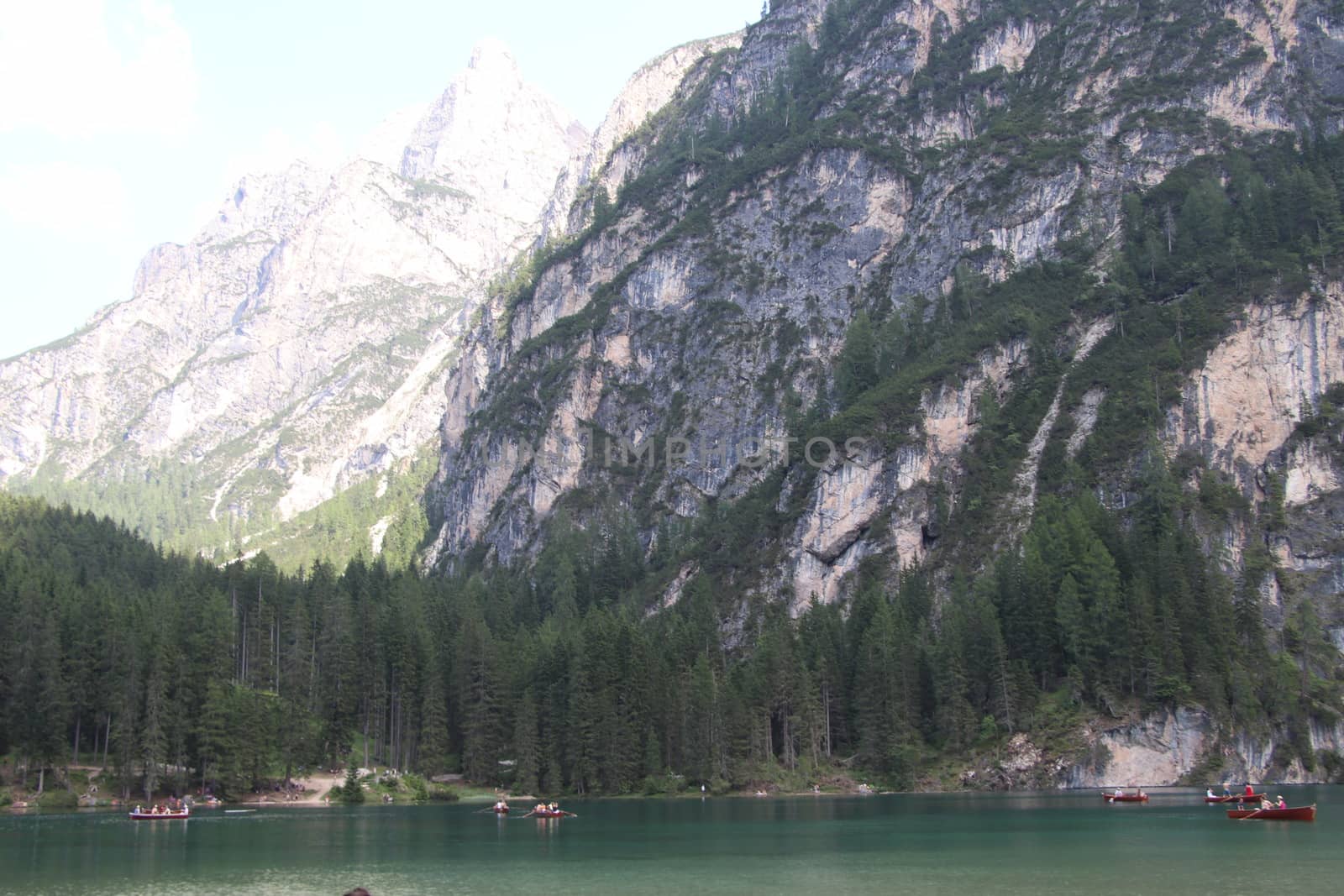 Rocky mountains with green forests at Lago di Braies. Braies lake in the Dolomites in South Tyrol, Italy, a municipality of Braies, in the Prague Valley.