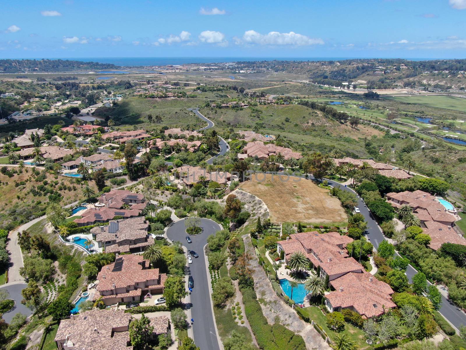 Aerial view of high class neighborhood with big residential mansions with swimming pool in the green valley, Pacific Highlands Ranch, San Diego, California, USA.