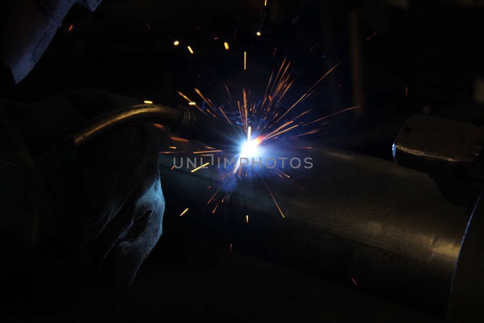 Metal welding. Sparks from electric heating. Iron, materials.Artistic welding sparks light, industrial background .