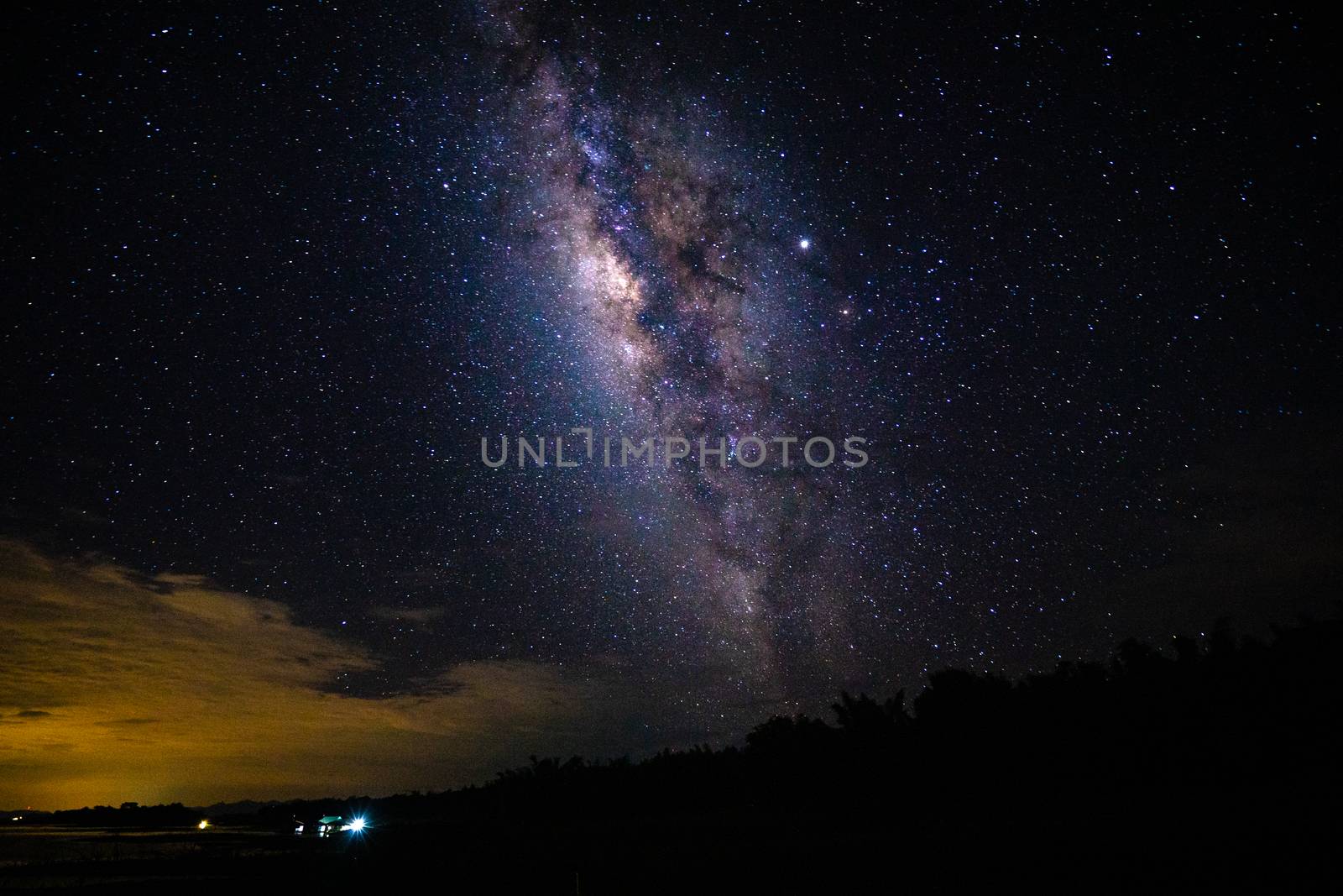 Night landscape with the Milky Way and light from home at mounta by domonite