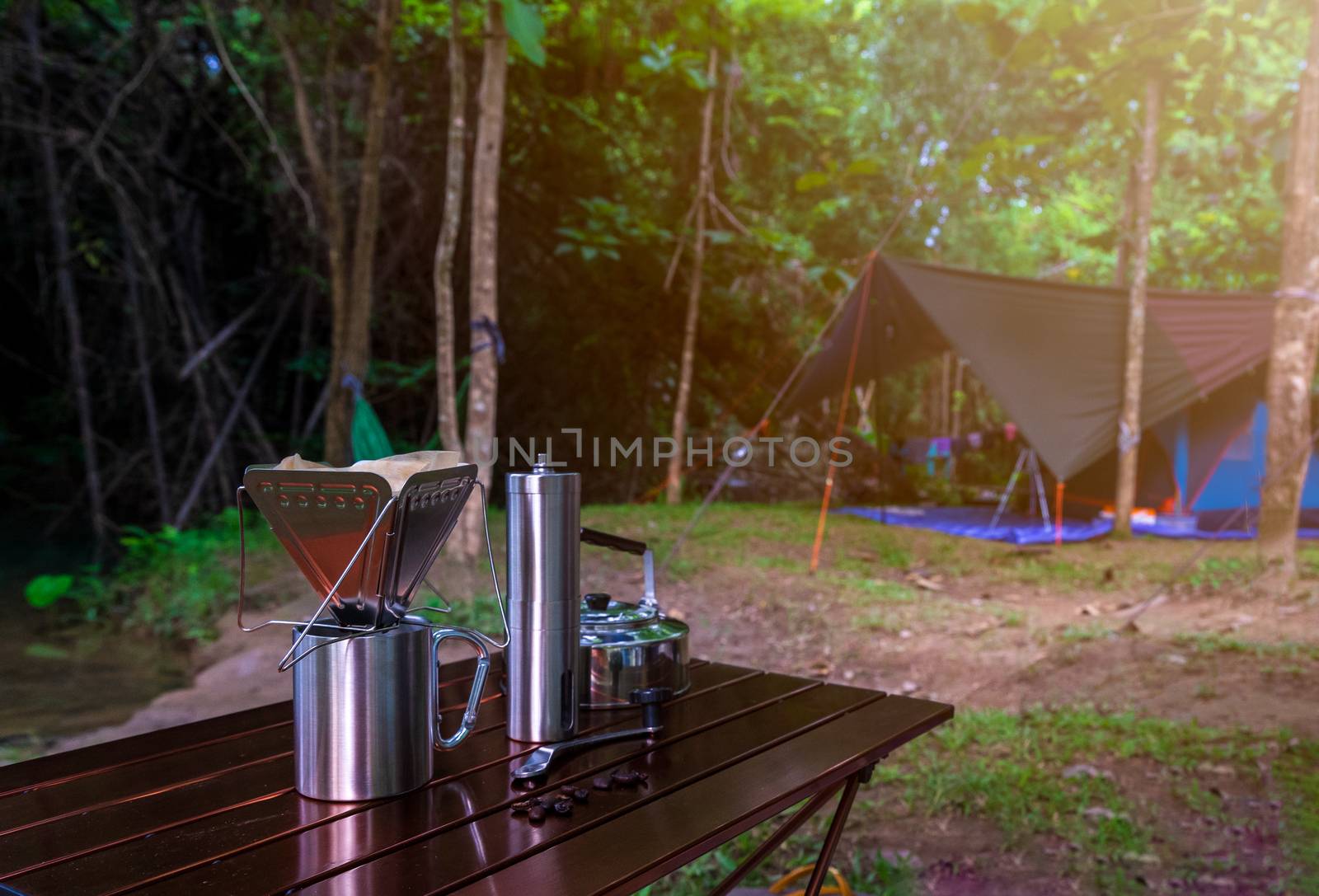 coffee drip while camping in nature park by domonite