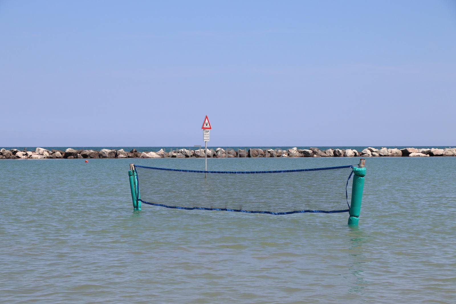 Empty volleyball net  on the sea  in summer.