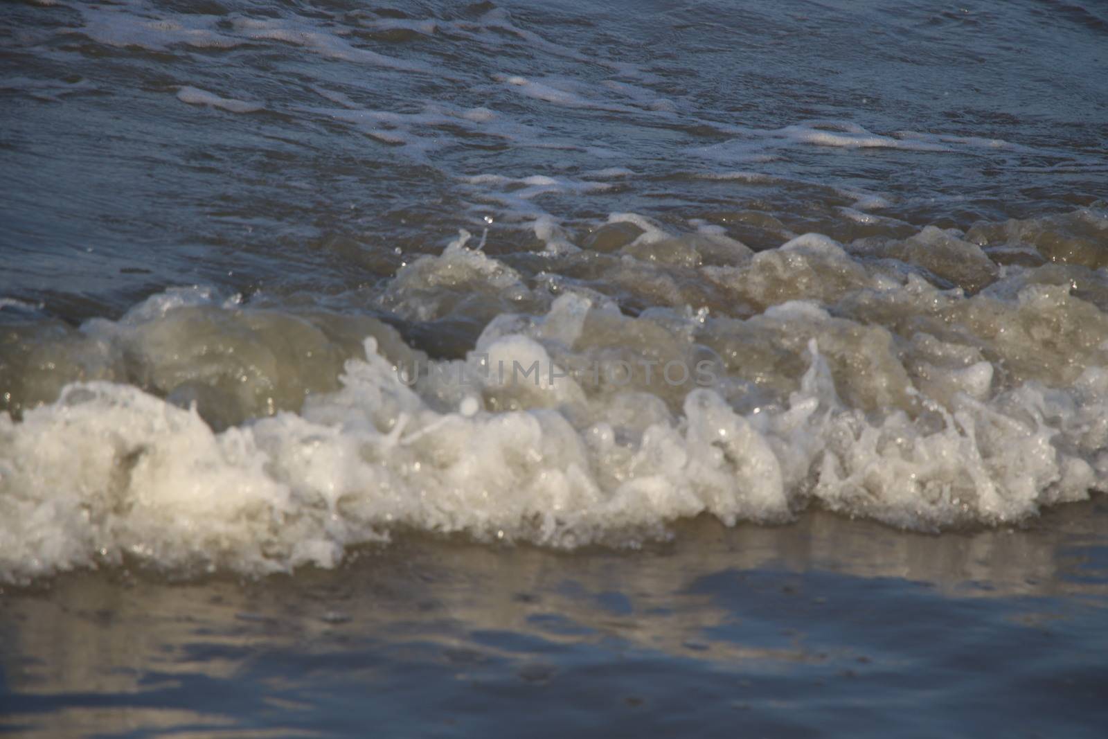 view of the blue ocean waves on the beach.