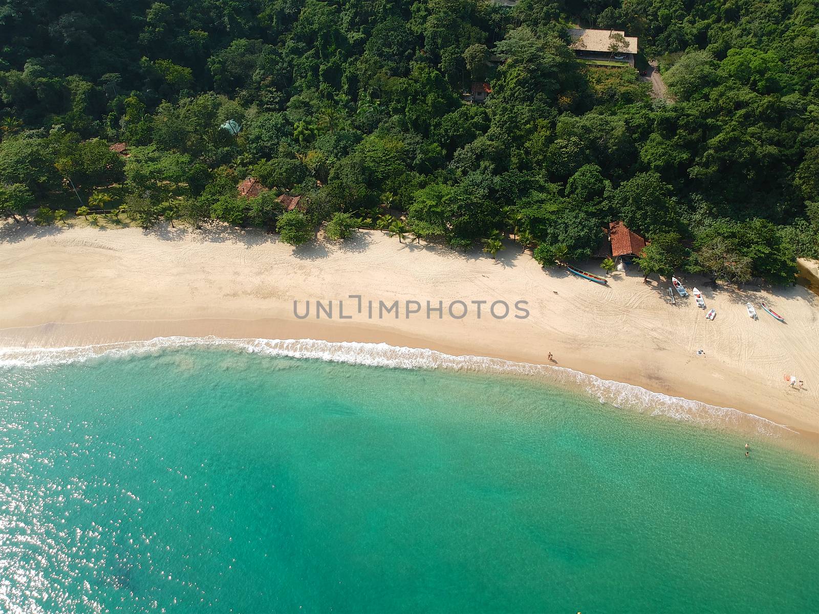Aerial view of white sandy beach with turquoise water in tropical country by Bonandbon