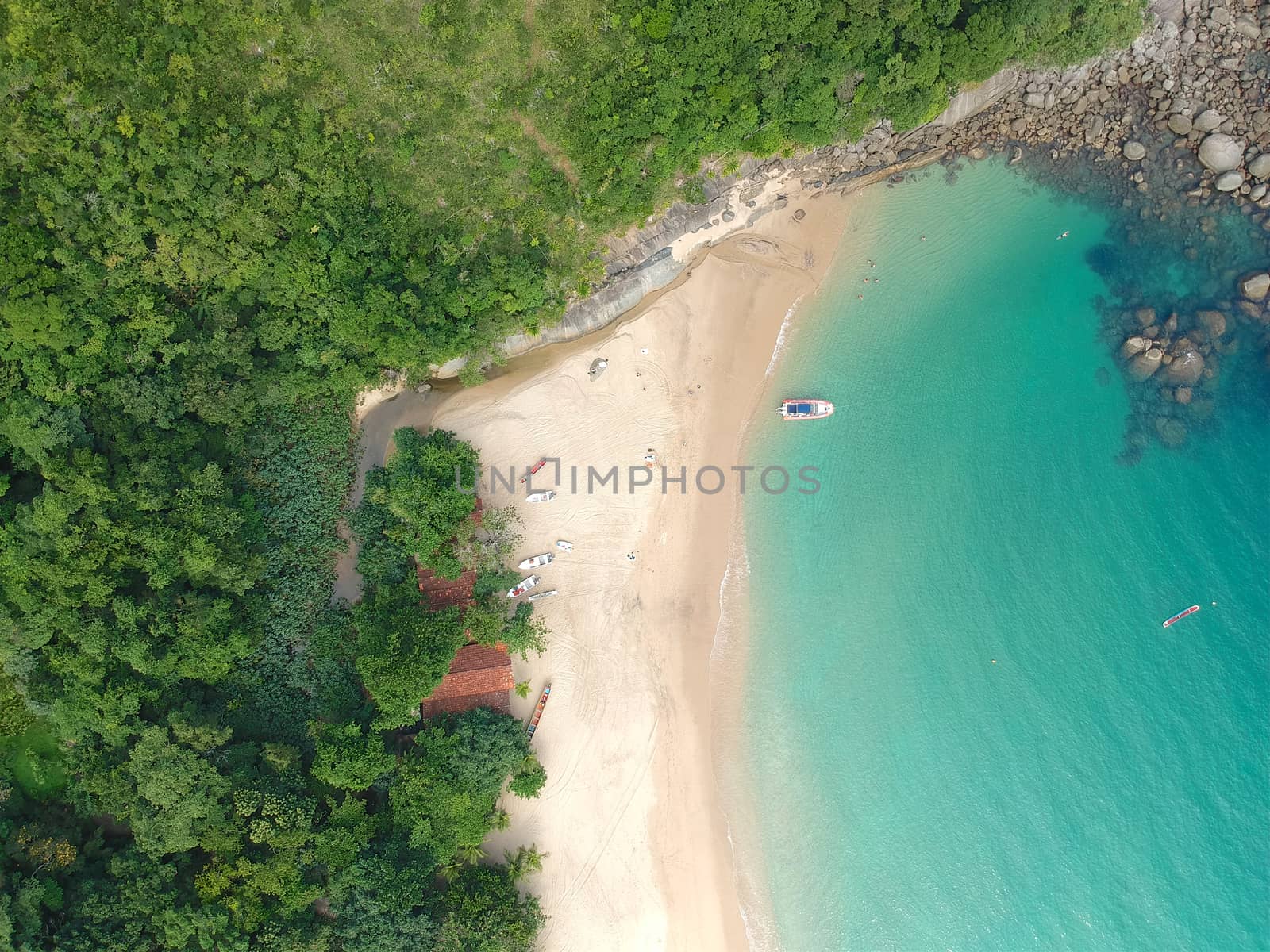 Aerial view of white sandy beach with turquoise water in tropical country by Bonandbon