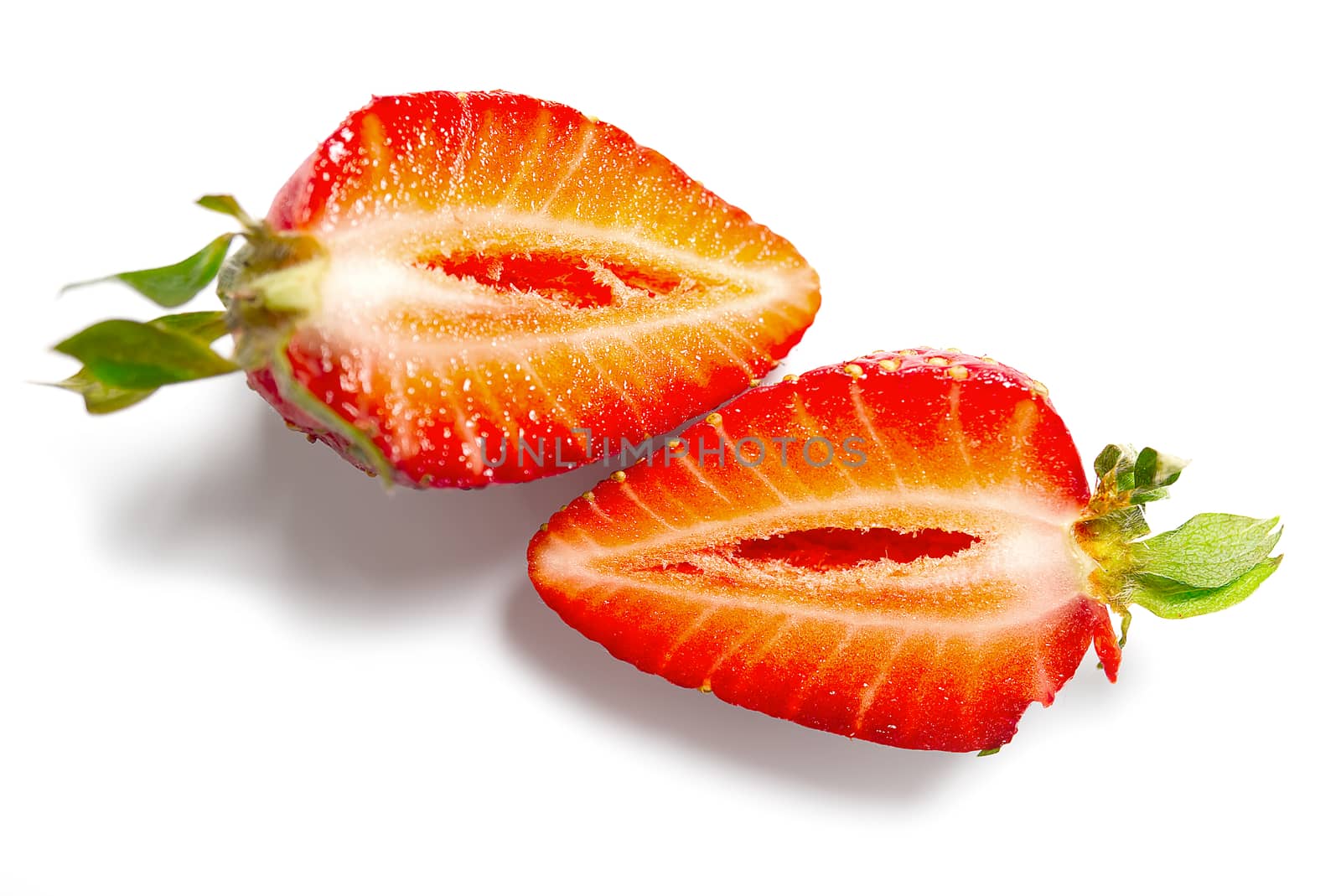 Fresh halved strawberry isolated on white background with clipping pat.