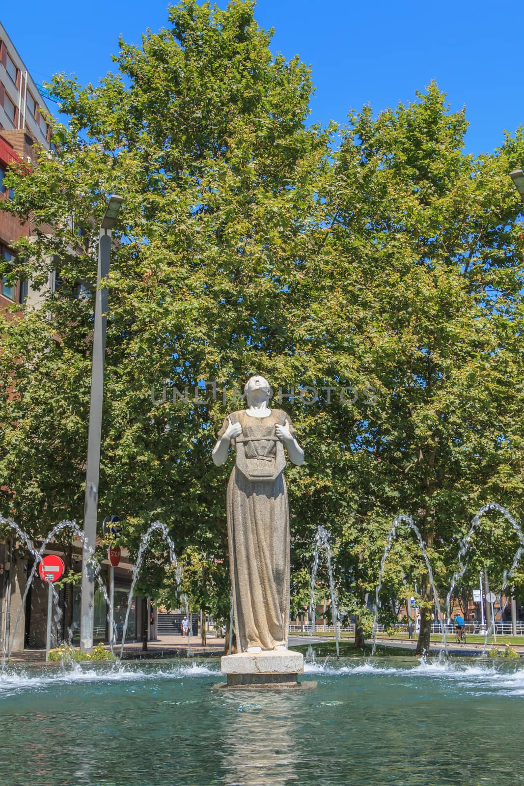 Bilbao, Spain - July 19, 2016 : statue of Melpomene, in Greek mythology the muse of singing, carved by Enrique Barros, under the sun on a summer day
