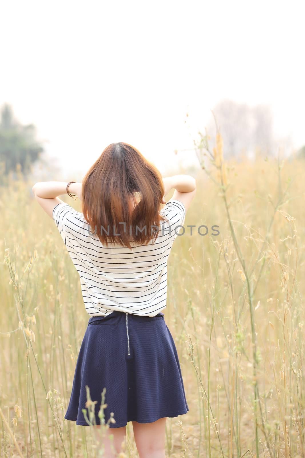 Young woman in wheat by piyato