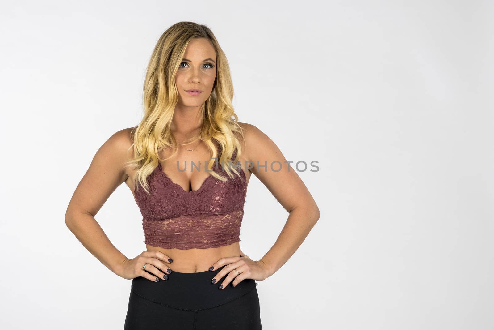 A gorgeous blonde model posing in a studio environment