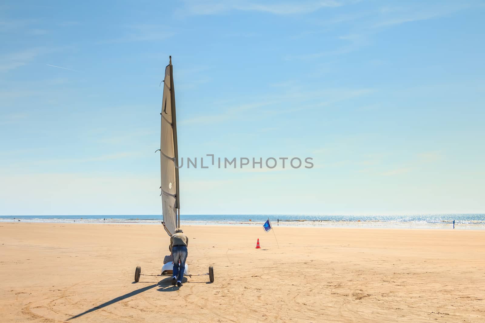 Saint Jean de Monts, France - September 23, 2017 : trainer pushes a sand yachting student who can not move forward at the end of the summer