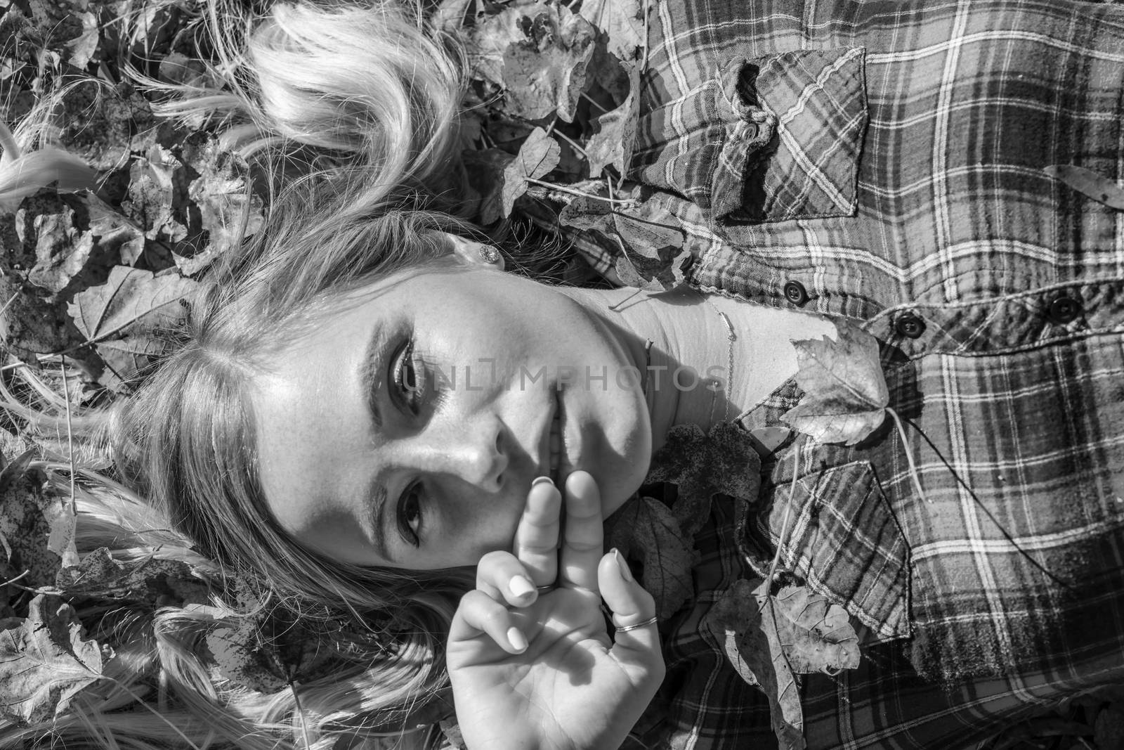 A gorgeous blonde model enjoys a Autumn day outdoors in a park