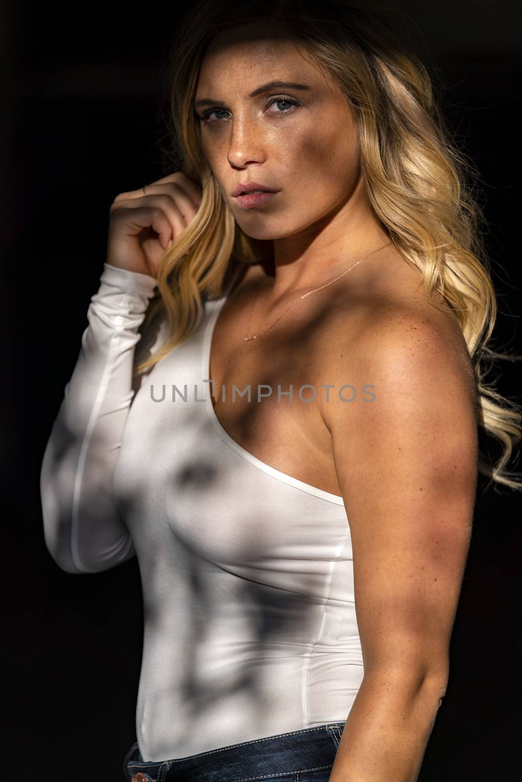 A gorgeous blonde model poses in a parking deck on an autumn day