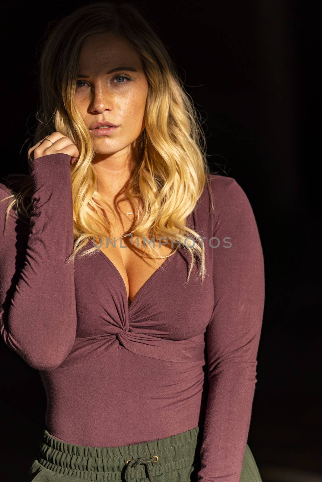 A gorgeous blonde model poses in a parking deck on an autumn day